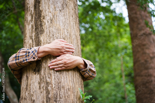 Forest conservationist gentle hugs tree in sunny park, deep care and respect for nature. Their hands embrace the trunk, reflecting commitment to environmental protection and sustainable ecosystems.