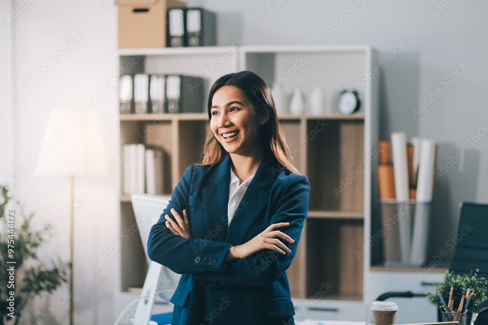 Portrait of Happy young Asian businesswoman looking at camera,arms crossed folded.Smiling woman executive manager,secretary offering professional business services standing in office. Portrait of Happy young Asian businesswoman looking at camera,arms crossed folded.Smiling woman executive manager,secretary offering professional business services standing in office.