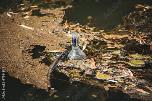 Close up of a Booze bottle in a river