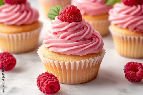 Cupcakes with pink frosting and fresh berry