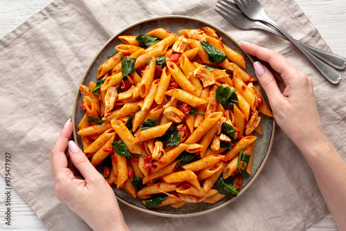 Wallpaper Mural Female hands hold a plate with homemade One-Pot Spinach And Tomato Pasta, top view. Torontodigital.ca