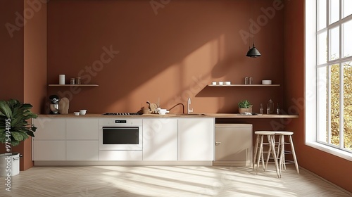 Modern kitchen interior with white cabinets, wooden countertops, and a terracotta wall. Sunlight streams through a large window.