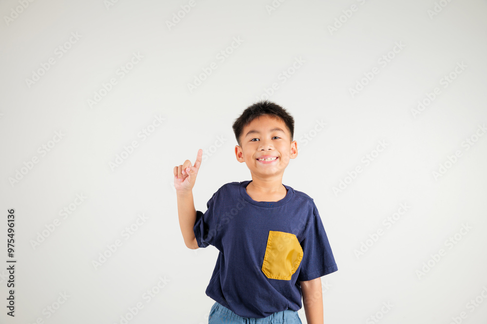 Asian happy portrait cute young kid boy makes gesture fingers point upwards above presenting product something, studio shot isolated on white background, primary children man smile Asian happy portrait cute young kid boy makes gesture fingers point upwards above presenting product something, studio shot isolated on white background, primary children man smile