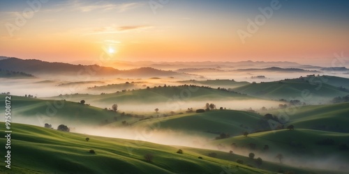 Aerial View of Rolling Green Hills with Morning Fog and Sunrise. photo