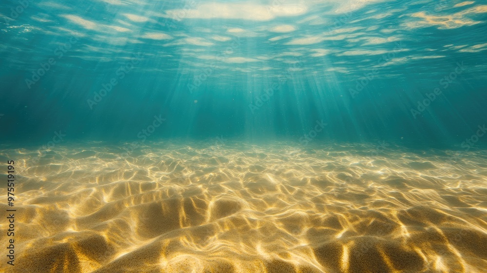 Naklejka premium Seabed of golden sand beneath a calm, tropical ocean, illuminated by the summer sun, casting beautiful light patterns underwater.