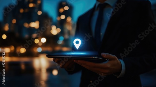 Businessman holding tablet with glowing location pin icon.