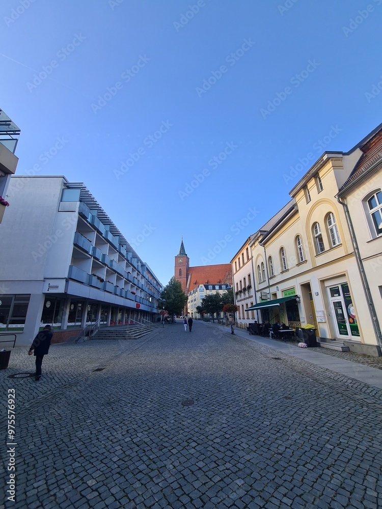 Naklejka premium Gehweg mit blauem Himmel und der Sankt - Marien - Kirche im Hintergrund - Stadtzentrum von Bernau bei Berlin, Brandenburg