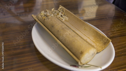 rice cooked with rice inside bamboo photo