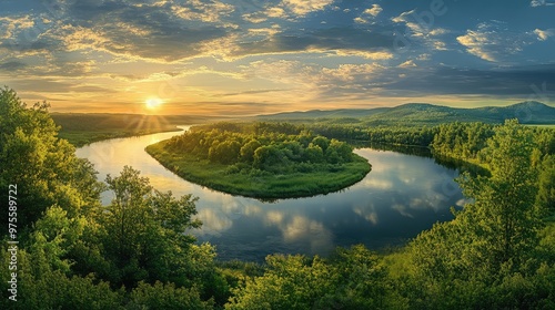 A curving river reflects the early morning sun, bordered by a lush forest in a stunning landscape panorama photo