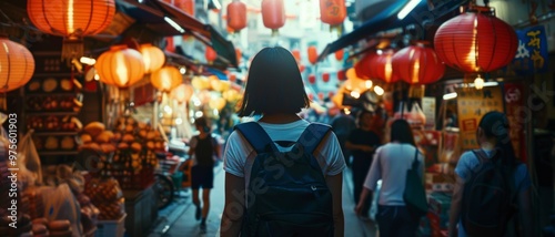 A person with a short bob hairstyle walks through a lively marketplace lit by hanging red lanterns, surrounded by diverse vendors and goods.