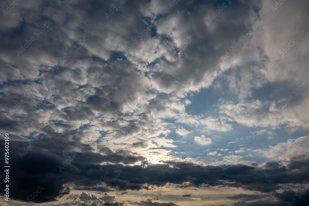 Cloudy summer sky at sunset with sunlight behind the clouds Cloudy summer sky at sunset with sunlight behind the clouds