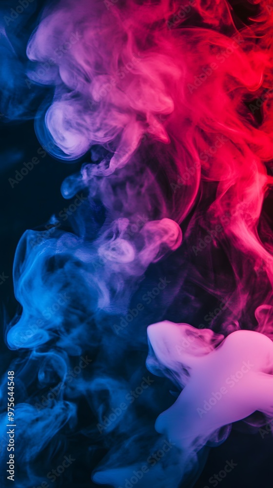 Fototapeta premium Abstract blue and pink smoke swirls on a black background.