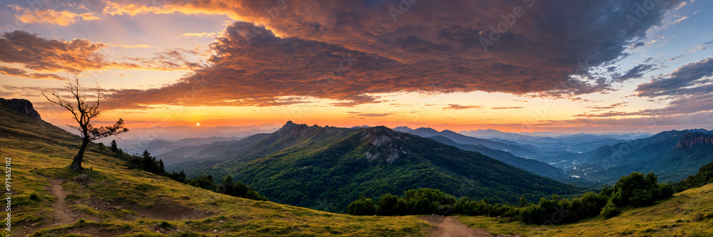 Fototapeta premium Golden hour sunset over a mountain landscape with panoramic views and calm orange skies, creating a peaceful and serene atmosphere ideal for capturing the beauty of nature during a relaxing summer eve