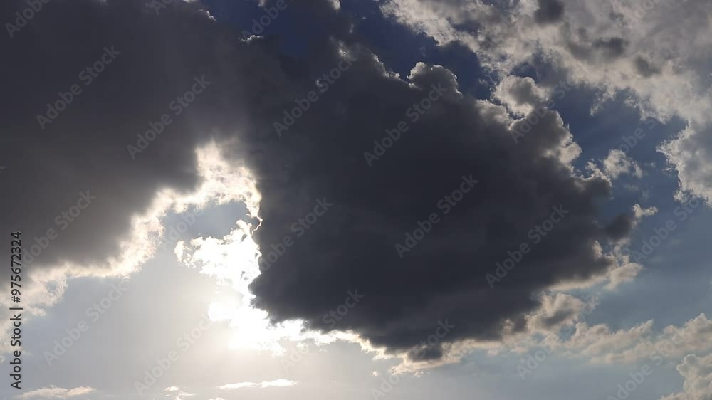 Time-lapse of dark clouds with sunlight breaking through, symbolizing hope, contrast, and transitions. Time-lapse of dark clouds with sunlight breaking through, symbolizing hope, contrast, and transitions.