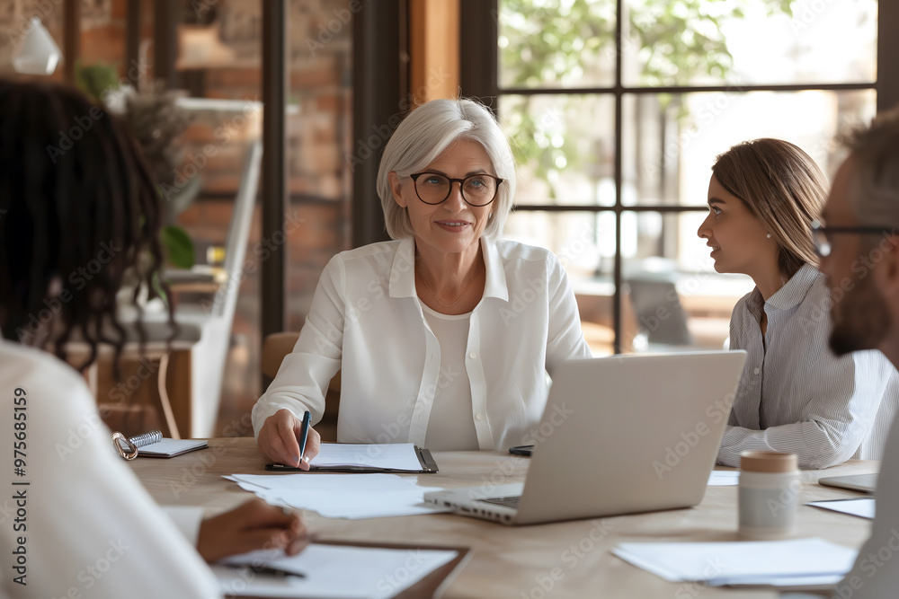 Fototapeta premium Mature Businesswoman Leading Boardroom Discussion