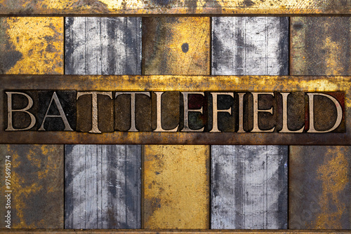 Battlefield text in real authentic typeset letters on vintage textured silver grunge copper and gold background