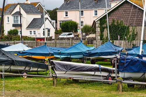 Colorful Boats Covered in Tarps at Harbor in Penzance, Cornwall, UK #975695962