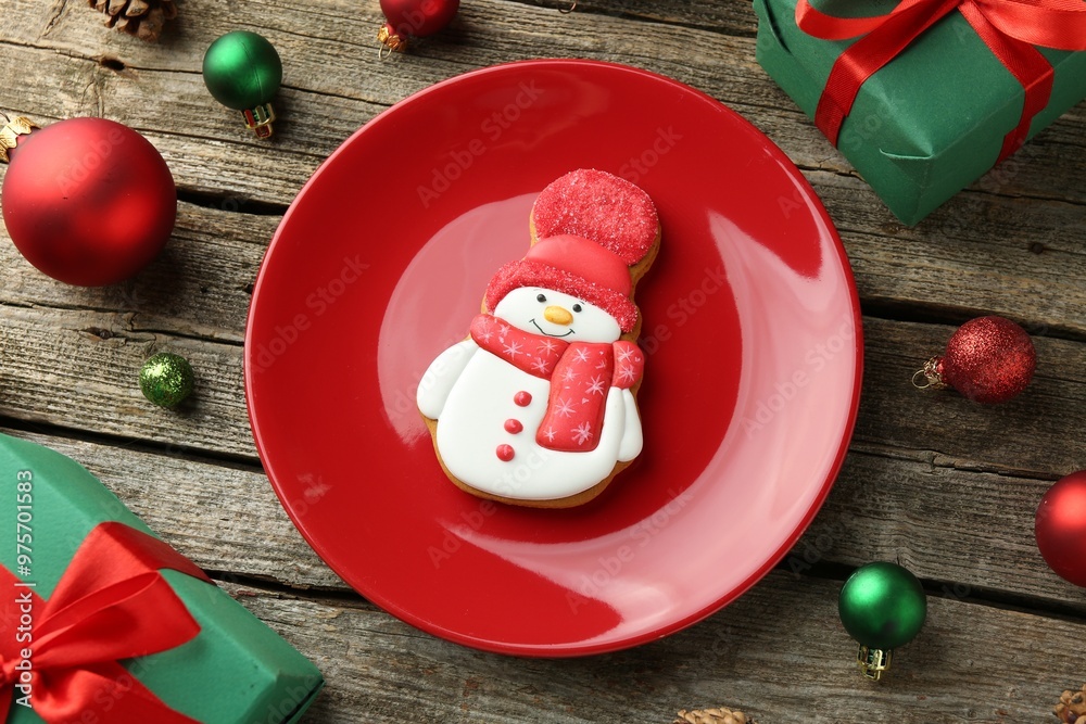 Delicious cookie in shape of snowman and Christmas decor on wooden table, flat lay Delicious cookie in shape of snowman and Christmas decor on wooden table, flat lay