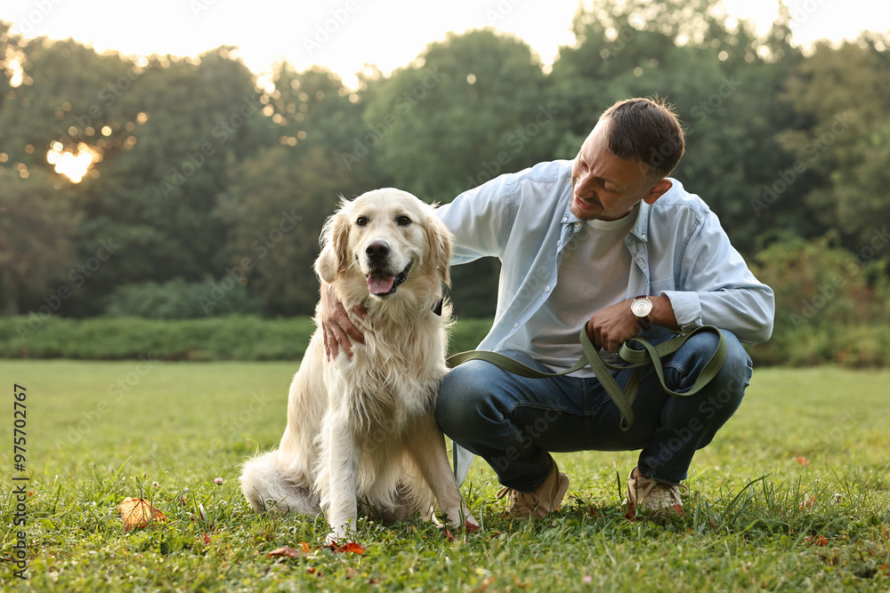 Smiling man with cute Golden Retriever dog on spring day Smiling man with cute Golden Retriever dog on spring day