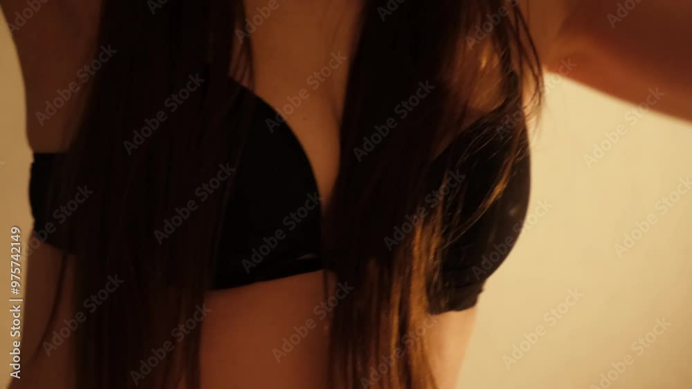 Breasts of sexy girl in black bra. Young confident woman dancing erotic dance. Brunette with long hair. Concept of love and foreplay of sex. Beautiful fit body. Arousal and lust. 4K Breasts of sexy girl in black bra. Young confident woman dancing erotic dance. Brunette with long hair. Concept of love and foreplay of sex. Beautiful fit body. Arousal and lust. 4K