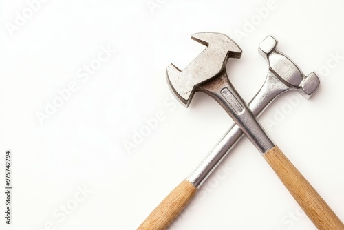 A hammer and a wrench crossed together, symbol of construction and repair, isolated on white background