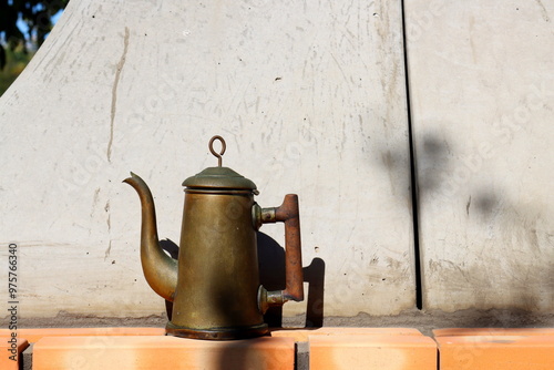 Antique metal teapot on the terrace of the house
