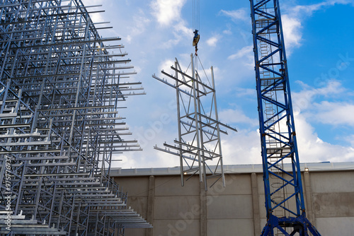 Fotografi Crane in process of ASRS clad rack structural framework installation