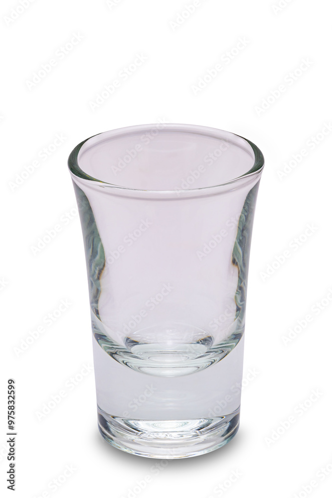 Closeup vertical view of single empty transparent shot drink whisky glass isolated on white background with clipping path Closeup vertical view of single empty transparent shot drink whisky glass isolated on white background with clipping path