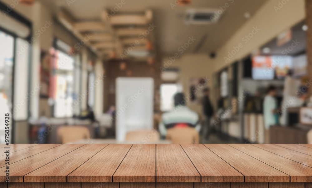Empty wooden table top with bokeh lights in a blurred restaurant background. Empty wooden table top with bokeh lights in a blurred restaurant background.