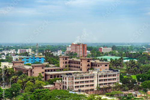 Obraz na płótnie Urban landscape with dense development colorful buildings and lush greenery, showcasing the dense architectural layout of city, Rajshahi, Bangladesh. w salonie