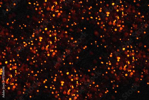 Abstract background showing orange particles floating on black background