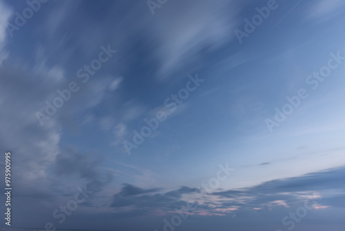 A moody twilight scene showcasing a dark sky with soft cloud silhouettes. The fading light on the horizon provides a subtle glow, adding a calm yet mysterious atmosphere to the composition.