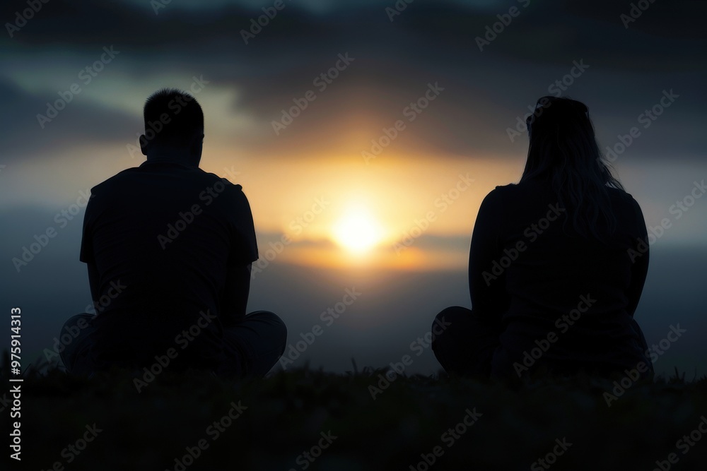 Silhouettes of Love at Sunset: A couple sits side-by-side, silhouetted against a breathtaking sunset, their backs to the camera as they gaze out at the horizon. The image evokes a sense of peace, tran Silhouettes of Love at Sunset: A couple sits side-by-side, silhouetted against a breathtaking sunset, their backs to the camera as they gaze out at the horizon. The image evokes a sense of peace, tran