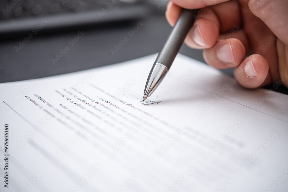 Business Professional Signing Important Legal Documents with a Pen on a Desk Surface, Symbolizing Commitment and Formal Agreement in Modern Office Environment Business Professional Signing Important Legal Documents with a Pen on a Desk Surface, Symbolizing Commitment and Formal Agreement in Modern Office Environment