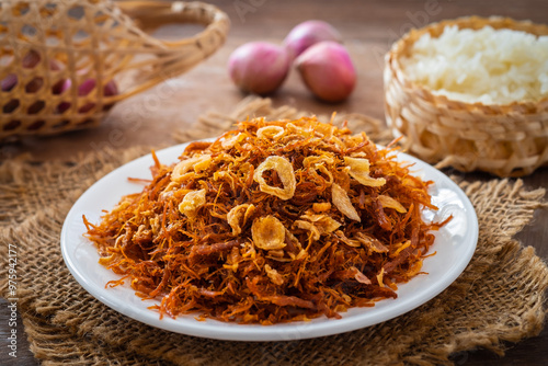Fried shredded pork on white plate and sticky rice (Moo Foi), Thai food