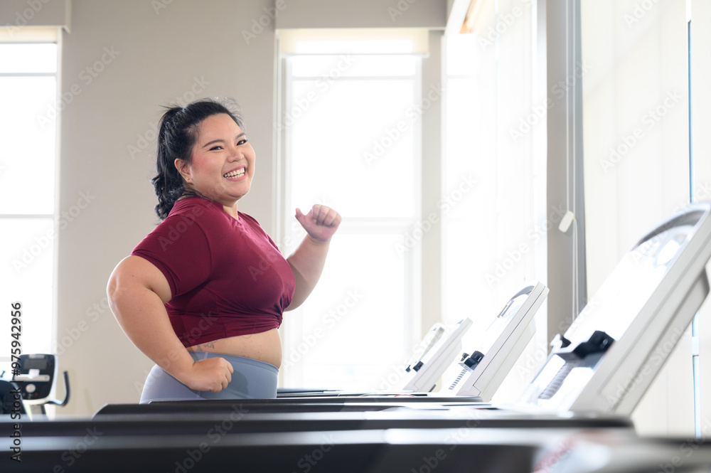 Asian overweight women in sportswear running on treadmill in fitness club. Weight loss workout, healthy lifestyle concept.