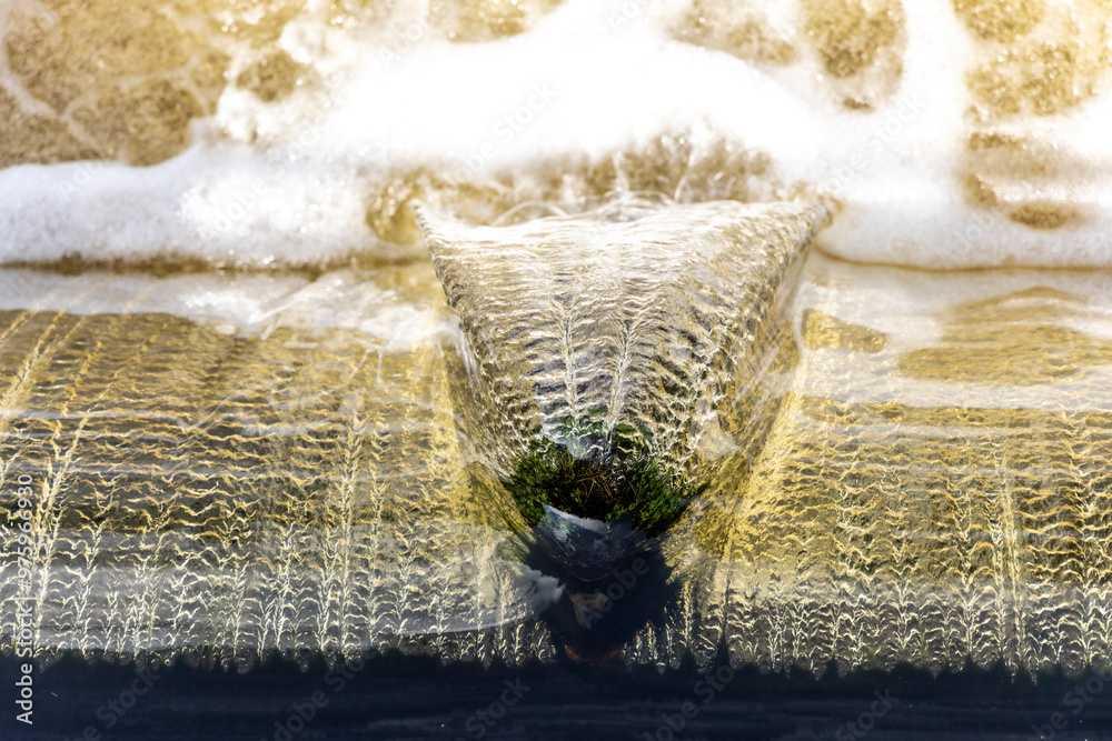 Top view of water flowing over an edge