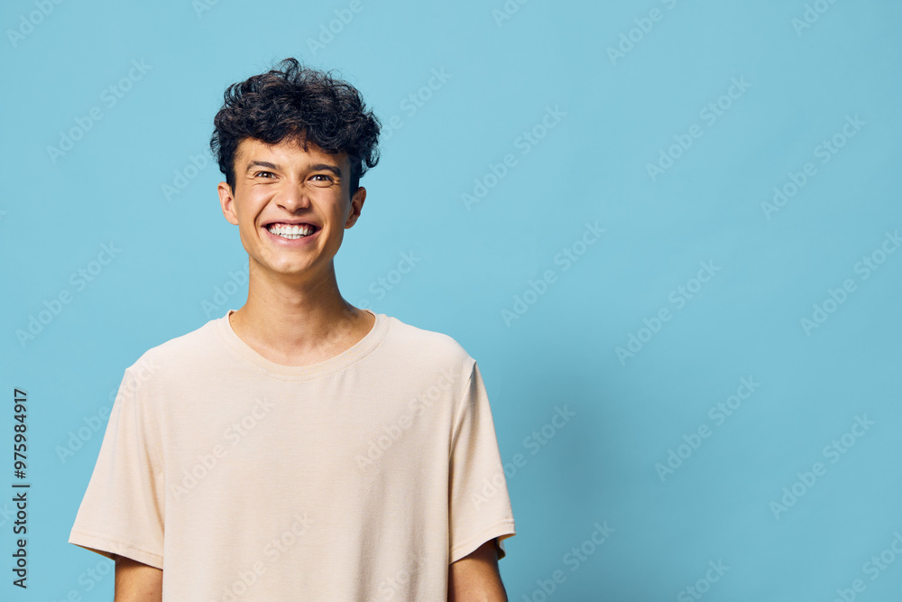 happy young man smiling against a light blue background, casual attire, joyful expression, vibrant colors capturing positivity and youthfulness, ideal for stock photo usage happy young man smiling against a light blue background, casual attire, joyful expression, vibrant colors capturing positivity and youthfulness, ideal for stock photo usage
