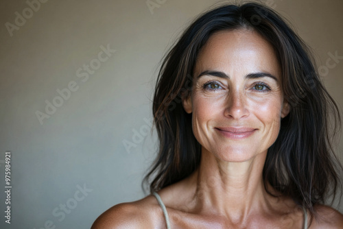 A woman smiles warmly in a natural setting, showcasing her beauty and confidence, captured during a calm afternoon