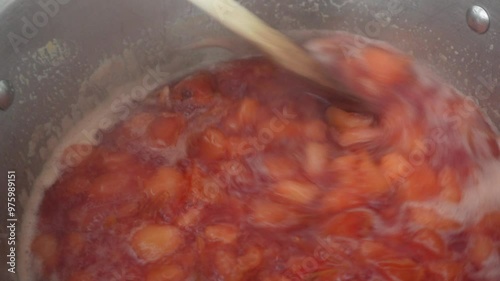 Making plum jam in a saucepan