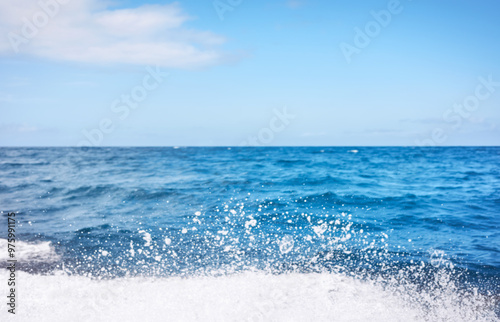 Blurred photo of sky and sea with splashing water, travel background. photo