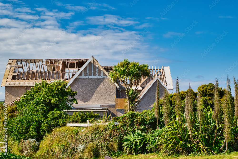 Partially Constructed House Surrounded by Lush Greenery at Towan Beach, Newquay, UK Partially Constructed House Surrounded by Lush Greenery at Towan Beach, Newquay, UK