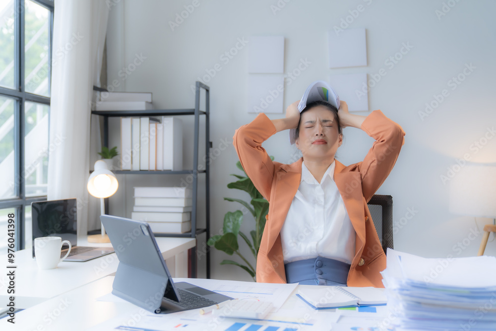 Obraz premium Sad Tired Asian woman Overworked On Computer.Unhappy Frustrated Business Woman, Business Finance Deadline.Sad Tired Businesswoman In Office.Annoyed Overwhelmed Exhausted Stressed