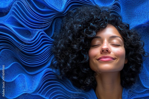Woman resting on blue textured fabric symbolizing serenity peace and the calming energy of inner reflection in a soft contemplative setting