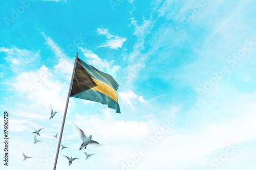 Bahamas flag waving with flying doves in beautiful sky. Bahamas flag for Republic Day and Independence Day. photo
