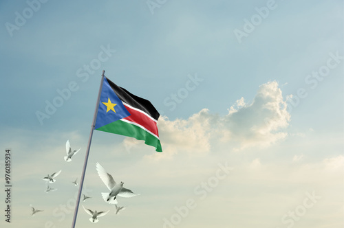 South Sudan flag waving with flying doves in beautiful sky. South Sudan flag for Republic Day and Independence Day.