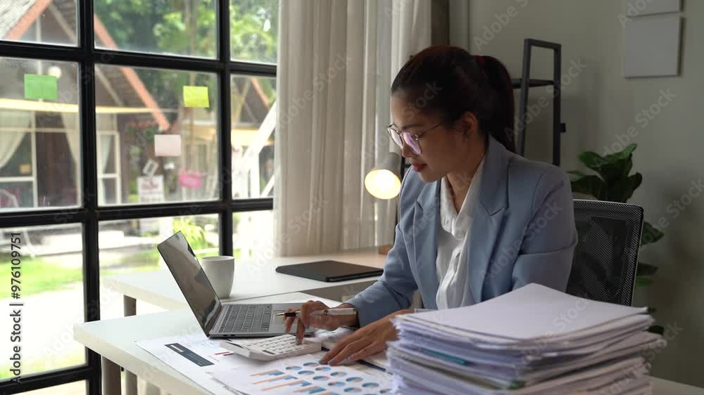 Young Asian business woman siting on the chiar working with laptop on the desk, Making opportunities female working successful in the office. Young Asian business woman siting on the chiar working with laptop on the desk, Making opportunities female working successful in the office.