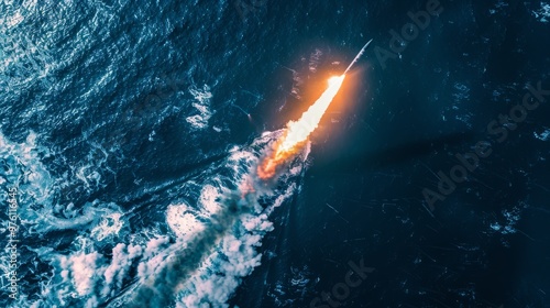 Aerial view of missile launchfrom warship towards distanttarget, fiery trail in dark skyand ocean,showcasingmilitary strike intensity andprecision. photo