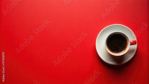 A coffee cup placed on top of a vibrant red surface