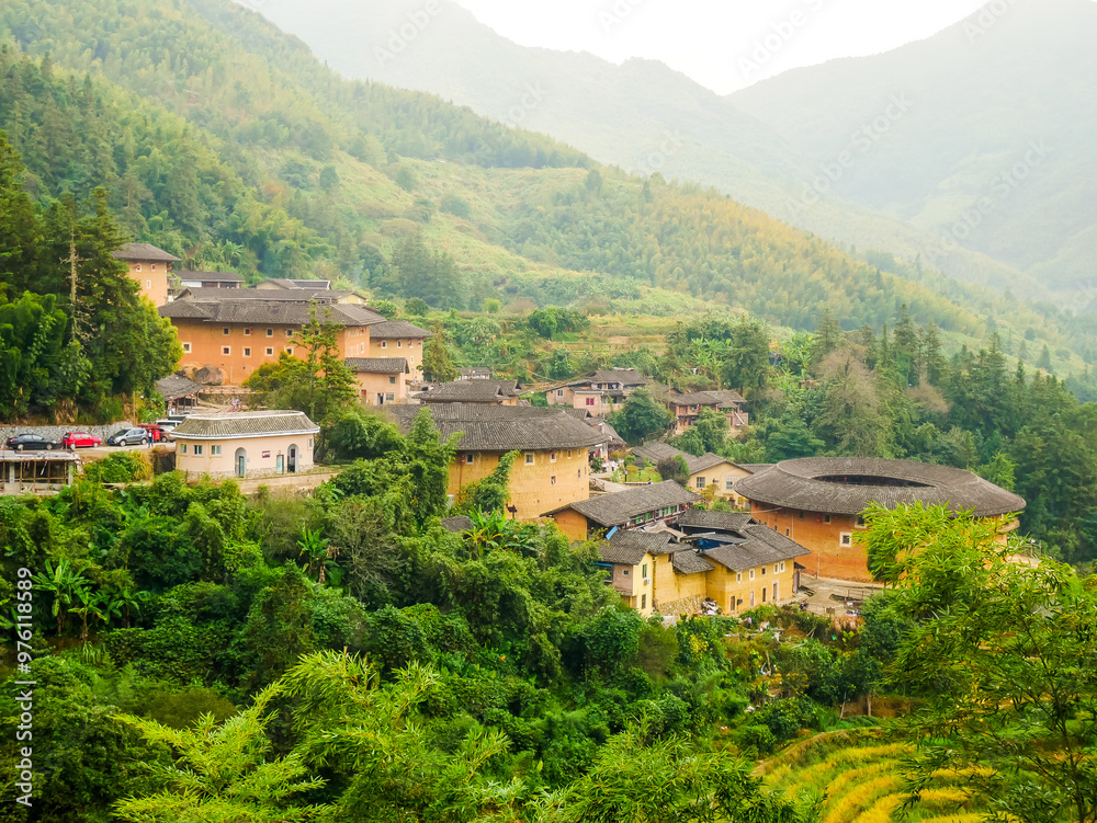 aerial view of Tianluokeng Tulou cluster with mist, located in Fujian,China aerial view of Tianluokeng Tulou cluster with mist, located in Fujian,China